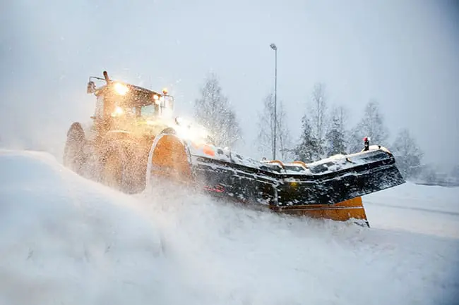 Loader doing snow management in a winter storm